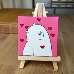 a small easel with a painting of a polar bear on it