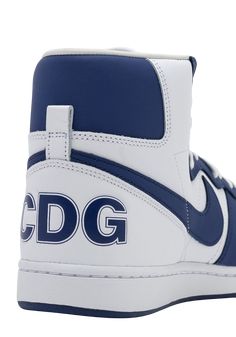 Details Final Sale CDG X NIKE Terminator High in NavyThe Comme Des Garçon Homme Plus Terminator High is in collaboration with Nike and provides the classic basketball shoe a simple but effective makeover in three colourways of supple buffed leather. The sneaker features the signature swoosh at the sides accompanied by bold CDG printed branding at the left heel counter. Classic details such as a padded tongue and collar, treaded rubber outsole, and perforated toe details round out the approachabl Nike Terminator, Promotional Events, Terminator, Comme Des Garcons, Basketball Shoes, Sale Items, High Tops, Basketball, Branding