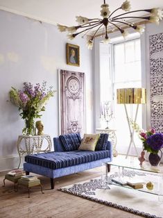 a living room filled with furniture and flowers