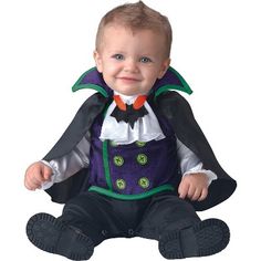 a baby dressed in a costume sitting on the ground