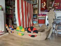 a child's room with toys and bookshelves in the shape of boats