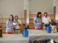 three people standing at a table with presents on it and one person holding a piece of paper