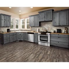 a kitchen with gray cabinets and wood flooring is featured in this ad for the kitchen renovations diy ideas