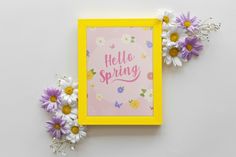 there is a yellow frame with some flowers on it and the words hello spring written in pink