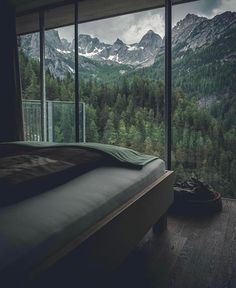 the instagram page shows an image of mountains and trees from inside a bedroom window