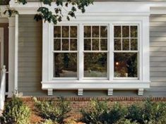 a house with white trim and two windows