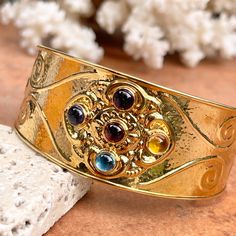 Estate/ vintage 14KT yellow gold Etruscan/ Byzantine cuff bracelets with cabochon gemstones. An amazing, colorful and high quality old-world style cuff! Weight: 15 grams Stamped 14K Italy Made in Italy Width: 28mm at widest point Tapers in back Semi-flexible Vintage Jeweled Gold Cuff Bracelet, Vintage Gold Bangle With Gemstone, Traditional Gold Cuff Bracelet With Gemstone, Gold Multi-stone Cuff Bracelet As Gift, Bohemian Gold Cuff Bracelet With Gemstone, Gold Multi-stone Cuff Bracelet For Gift, Gold Jeweled Cuff Bracelet As Gift, Gold Multi-stone Bangle As A Gift, Gold Jeweled Cuff Bracelet Perfect As A Gift