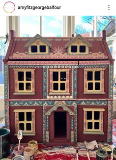 the doll house is painted and ready to be put into its new owner's home