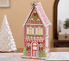 Home, sweet home. This gingerbread house is decadently detailed with icing and peppermint, while a light glittery finish and sugar-like snow dust the design that illuminates from inside. Display it on a tabletop, mantel, or shelf for a festive addition to your holiday decor. From the Valerie Parr Hill Collection. Valerie Parr Hill Christmas, Winter Tree Decorations, Rustic Christmas Stocking, Potter House, Santa North Pole, Gingerbread House Designs, Train Ornament, Valerie Parr Hill, Gingerbread House Decorations