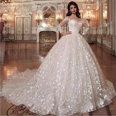 a woman in a white wedding dress posing for the camera