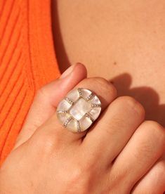 Generous curves, hexagonal lines, worked details; the sumptuous Reem ring in Mother-of-pearl is as much a technical feat as an aesthetic marvel. By borrowing its XXL shapes from those of a flower in full bloom, it lets its exceptional know-how, its multiple zircons and its fine natural stones shine. Cut nine times then polished by hand, these cabochons thus royally highlight the reflections, textures, tones and particularities of this extraordinary jewel. Aesthetic Marvel, In Full Bloom, Delicate Rings, Pearl Size, Ring Handmade, Pearl Ring, Ring Necklace, Everyday Look, The Borrowers