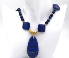 Lapis Lazuli beaded necklace.  Handmade gemstone necklace with gold beads.  Vivid blue lapis necklace with pendant. Lapis Lazuli is an alternative birthstone for September.  Anniversary, birthday and graduation jewelry.  An ideal gift for her.  MATERIALS AND SIZE 9mm round lapis lazuli beads 21x21mm square lapis lazuli beads 7mm, 5mm, 3mm and 2mm round gold filled beads 6mm gold filled jump rings gold filled lobster claw clasp The necklace is 19.5 inches long The pendant adds another 2.25 inches Lapis Lazuli Beaded Necklaces For Gift, Lapis Lazuli Round Beads Necklace For Gift, Lapis Lazuli Gemstone Beads Necklace For Gift, Single Strand Lapis Lazuli Beaded Necklace As Gift, Lapis Lazuli Gemstone Beads Pendant Necklaces, Lapis Lazuli Pendant Beaded Necklace As Gift, Lapis Lazuli Pendant Necklace With Gemstone Beads, Lapis Lazuli Pendant Beaded Necklace For Gifts, Lapis Lazuli Gemstone Beads Pendant Necklace