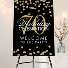 a black and gold birthday sign with confetti on it