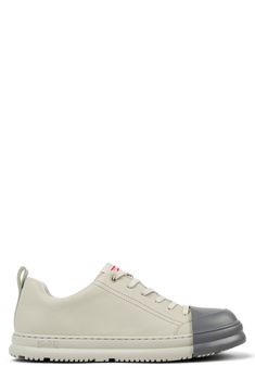 A sharply contrasting cap toe adds iconic Camper quirkiness to this classic sneaker set on a cushioned footbed. Lace-up style Leather and synthetic upper/textile lining/synthetic sole Imported Outdoor Low-top Sneakers With Rubber Toe Cap, Urban Sneakers With Rubber Toe Cap, Modern Low-top Sneakers With Rubber Toe Cap, Pastel Grey, Sneaker Men, Classic Sneakers, Up Styles, Nordstrom, Lace Up