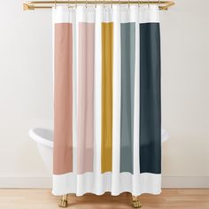 a shower curtain with different colors and shapes on the wall next to a bathtub