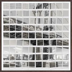 an image of the brooklyn bridge taken through some squares of cut - up paper in black and white