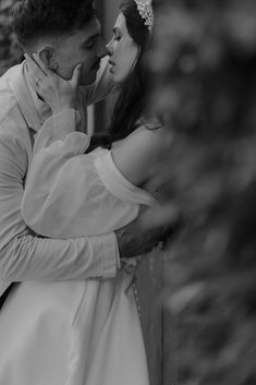 black and white photograph of a bride and groom kissing