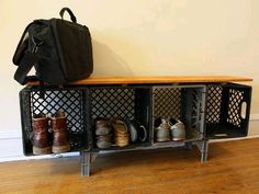 a black suitcase sitting on top of a wooden shelf filled with shoes and booties