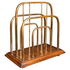 a set of three metal and wood magazine racks on wooden bases, each with four different sections