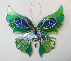 a stained glass butterfly hanging on the wall