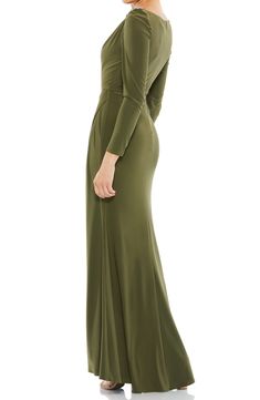 Subtle gathering at the hip and shoulder flatter your figure in an elegant long-sleeve gown finished with twinkling crystals at the shoulder. 63" length Bateau neck Long sleeves Lined 100% polyester Spot clean Imported Fitted Bodice Long Sleeve Dinner Gown, Dinner Gown With Fitted Bodice And Long Sleeves, Long Sleeve Gown With Fitted Bodice For Dinner, Fitted Long Sleeve Ruched Evening Dress, Long Sleeve Ruched Evening Dress, Ruched Long Sleeve Maxi Dress With Fitted Bodice, Long Sleeve Ruched Evening Dress For Formal Occasions, Elegant Long Sleeve Stretch Gown, Formal Long Sleeve Ruched Evening Dress