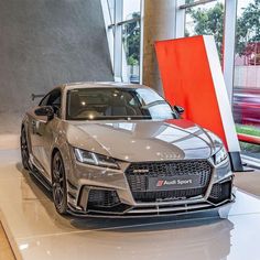 an audi sports car on display in a showroom