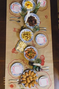 a long table with plates and bowls on it