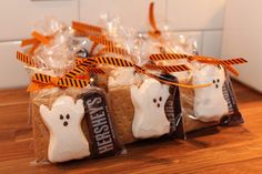 halloween treats wrapped in cellophane and tied with orange ribbon on wooden counter top