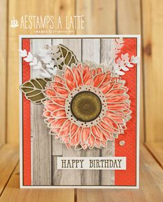 a birthday card with an orange flower on the front and white flowers on the back