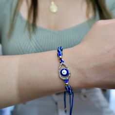 The Evil Eye charm has been used for centuries as a talisman for protection against misfortunes and malicious intent. It is thought to bring the wearer good luck.This adjustable sliding knot bracelet comes in an assortment of evil eye styles in a gold finish. Adjustable Evil Eye Bracelet With Sliding Knot, Adjustable Spiritual Evil Eye Bracelet With Sliding Knot, Adjustable Teardrop Evil Eye Jewelry, Adjustable Bohemian Evil Eye Bracelet For Good Luck, Bohemian Evil Eye Bracelet For Good Luck, Adjustable Jewelry With Sliding Knot For Blessing, Spiritual Jewelry With Sliding Knot For Festivals, Adjustable Evil Eye Bracelet For Good Luck, Adjustable Symbolic Evil Eye Jewelry