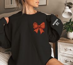 Copy/paste the link in your browser to Join our VIP club for exclusive offers: https://shop.activealluredesigns.com/ Take your basketball fandom to the next level with this stylish customizable basketball bow sweatshirt! Featuring a unique basketball-themed bow on the front, this sweatshirt is perfect for basketball lovers who want to combine sporty flair with personal style. Customize the sleeve with your name and jersey number to make it truly one-of-a-kind. SLEEVE PRINT: Please note the name Custom Made Basketball Shirts For Boyfriend, Basketball Hoodies For Boyfriend, Basketball Girlfriend Hoodies, Basketball Shirts For Girlfriends Long Sleeve, Basketball Hoodies, Long Sleeve Basketball Sweatshirt, Custom Basketball, Mom Hoodies, Basketball Mom