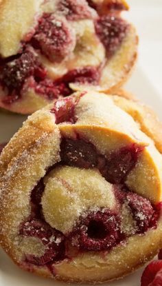 two raspberry filled pastries on a white plate