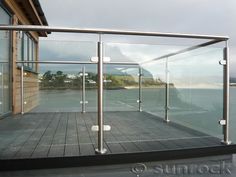 a glass balcony overlooking the ocean on a cloudy day