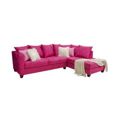 a pink couch and ottoman with pillows on it