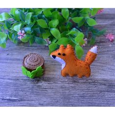 a small toy squirrel next to a tree stump