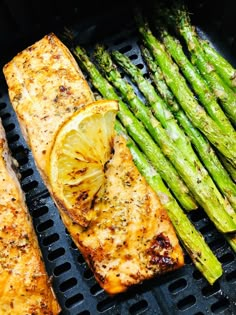 grilled salmon and asparagus on a grill with the words air fryer lemon garlic salmon