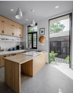 an open kitchen with wooden cabinets and white counter tops, along with a large window