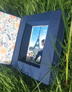 an open photo album with the eiffel tower in the background