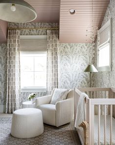 a baby's room with white furniture and curtains