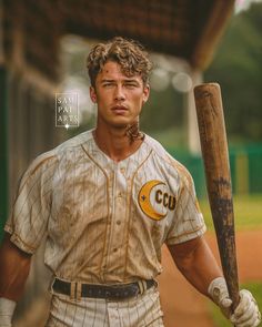 a man holding a baseball bat on top of a field