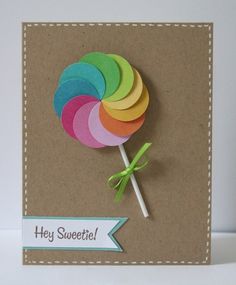 a card with a colorful lollipop on it's side and the words hey sweet