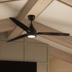 a ceiling fan mounted to the side of a wooden beam in a room with white walls