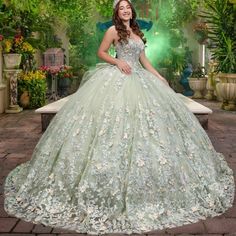 a woman in a green ball gown posing for the camera