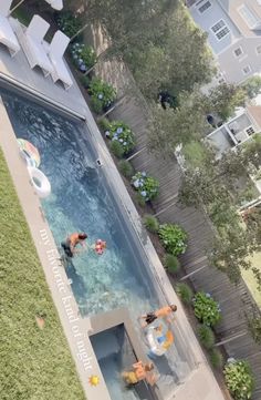 an aerial view of people swimming in the pool