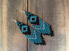 These western/boho style earrings are a beautiful blend of classic black , silver and turquoise. They are made with glass seed beads and silver plated earwires. they are surprisingly lightweight and easy to wear ❤️ Southwestern Tassel Earrings For Festivals, Bohemian Turquoise Beaded Earrings With Black Beads, Adjustable Southwestern Black Earrings, Handmade Southwestern Black Beaded Earrings, Handmade Black Southwestern Beaded Earrings, Southwestern Black Beaded Earrings For Gift, Southwestern Black Beaded Earrings For Festivals, Black Southwestern Dangle Earrings, Southwestern Black Festival Earrings