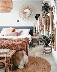 a bedroom with plants and mirrors on the wall