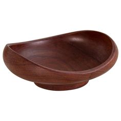 a wooden bowl sitting on top of a white surface