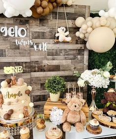 a teddy bear themed dessert table at a baby shower or birthday party with balloons and decorations