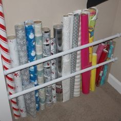 several rolls of wrapping paper sitting on top of a shelf next to candy canes