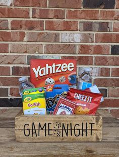 a game night box filled with candy and snacks sitting on top of a wooden table